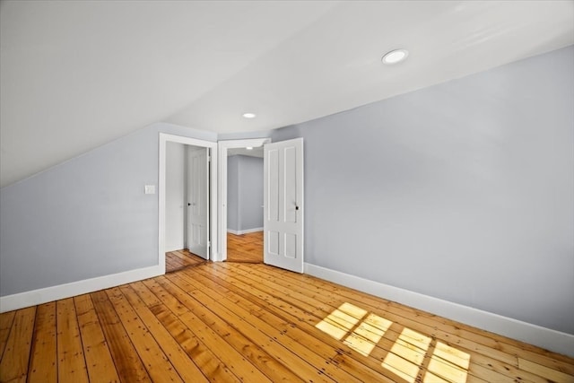 bonus room with vaulted ceiling and light hardwood / wood-style floors