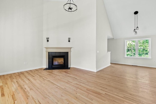 51 Old Stagecoach Rd, Attleboro, MA 02703 - unfurnished living room with high vaulted ceiling, light wood-style floors, a fireplace, and baseboards