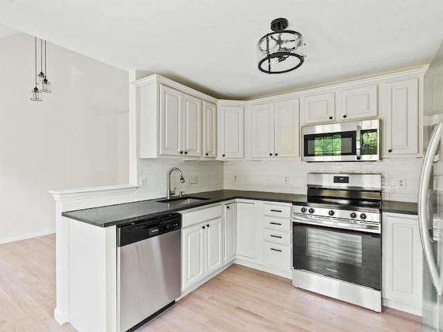 51 Old Stagecoach Rd, Attleboro, MA 02703 - kitchen featuring appliances with stainless steel finishes, a sink, dark countertops, and backsplash