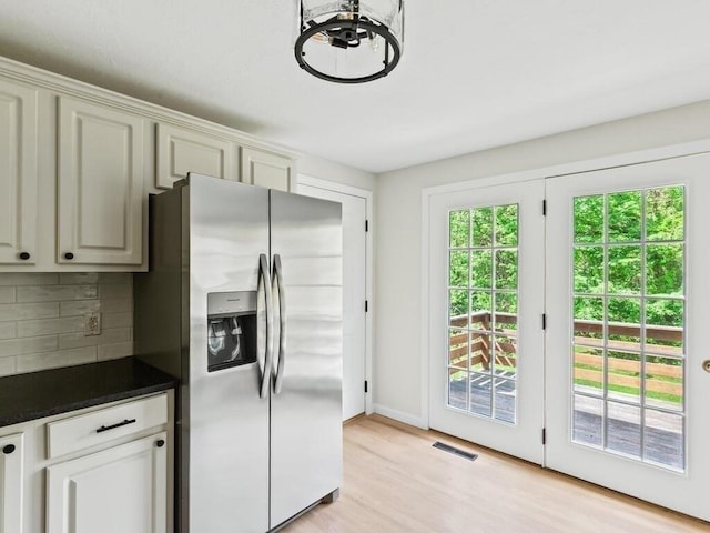 51 Old Stagecoach Rd, Attleboro, MA 02703 - kitchen featuring stainless steel refrigerator with ice dispenser, backsplash, dark countertops, light wood-type flooring, and baseboards