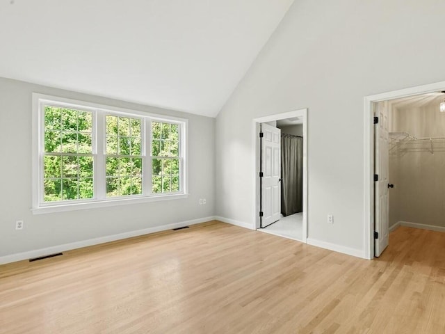 51 Old Stagecoach Rd, Attleboro, MA 02703 - unfurnished bedroom featuring a spacious closet, light wood-style flooring, baseboards, high vaulted ceiling, and connected bathroom