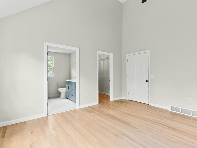 51 Old Stagecoach Rd, Attleboro, MA 02703 - unfurnished bedroom featuring high vaulted ceiling, baseboards, a spacious closet, light wood-style floors, and ensuite bath