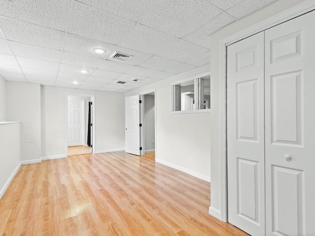51 Old Stagecoach Rd, Attleboro, MA 02703 - basement featuring a drop ceiling, light wood-style flooring, and baseboards