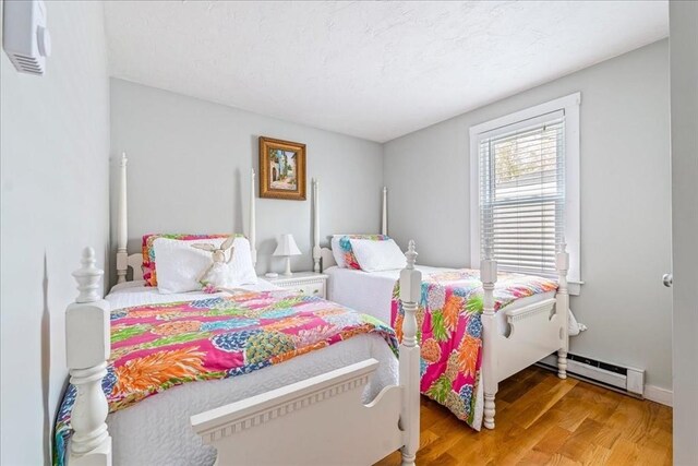59 Brigantine Cir, Plymouth, MA 02360 - bedroom with a baseboard radiator and wood finished floors