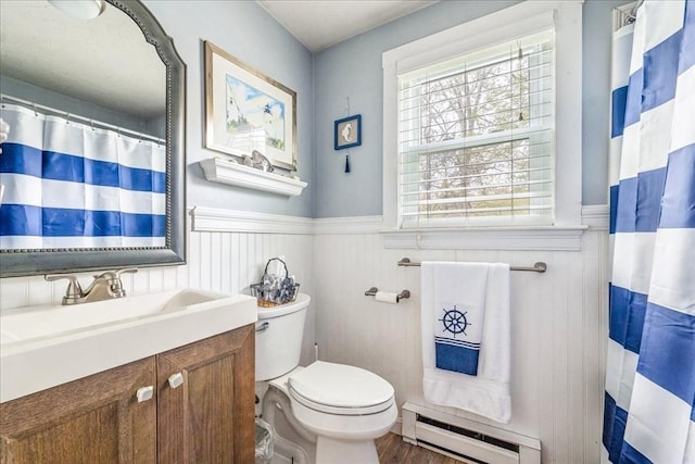 59 Brigantine Cir, Plymouth, MA 02360 - bathroom featuring a baseboard radiator, a wainscoted wall, toilet, vanity, and wood finished floors