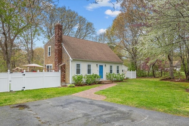 59 Brigantine Cir, Plymouth, MA 02360 - view of front of house featuring a shingled roof, a gate, and a chimney