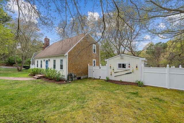 59 Brigantine Cir, Plymouth, MA 02360 - view of home's exterior with a chimney and a shingled roof