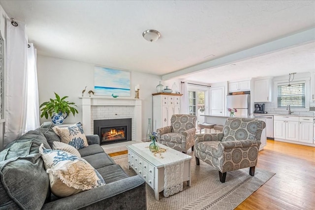 59 Brigantine Cir, Plymouth, MA 02360 - living area with healthy amount of natural light, light wood-type flooring, and a fireplace