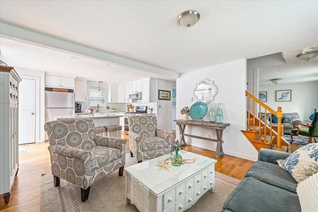 59 Brigantine Cir, Plymouth, MA 02360 - living area with light wood finished floors, stairway, and baseboards