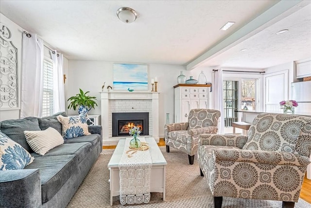 59 Brigantine Cir, Plymouth, MA 02360 - living area with a brick fireplace and light wood-style flooring