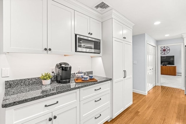 80 Christian Way, North Andover, MA 01845 - kitchen with stainless steel microwave, light wood-type flooring, white cabinetry, dark stone counters, and recessed lighting