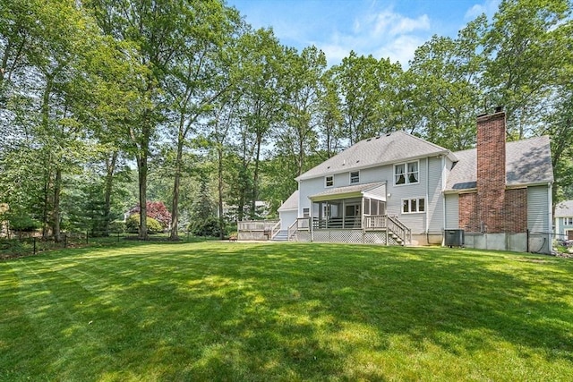 80 Christian Way, North Andover, MA 01845 - back of property with a sunroom, a chimney, stairway, and a deck