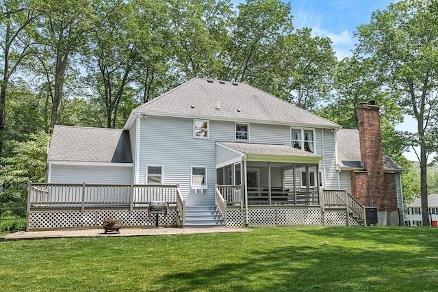 80 Christian Way, North Andover, MA 01845 - back of house with a sunroom, a deck, a lawn, a chimney, and roof with shingles