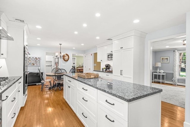 80 Christian Way, North Andover, MA 01845 - kitchen with light wood-type flooring, a center island, white cabinets, recessed lighting, and dark stone countertops