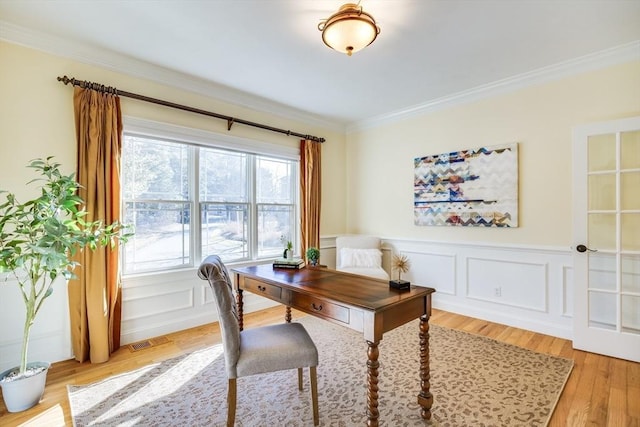 office space featuring crown molding and light hardwood / wood-style flooring