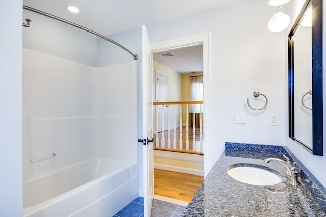 bathroom with tile patterned flooring, vanity, and tub / shower combination