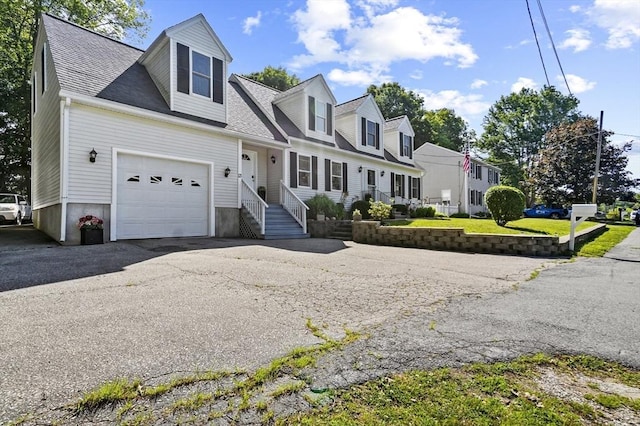 13 Hoyt Ave, Amesbury, MA 01913 - new england style home featuring a garage, asphalt driveway, a shingled roof, and a residential view