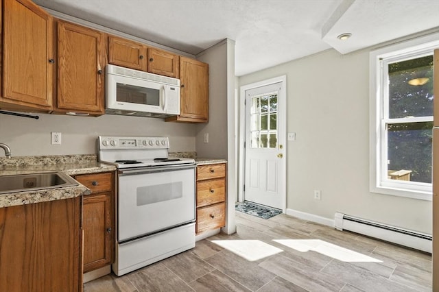 13 Hoyt Ave, Amesbury, MA 01913 - kitchen with white appliances, a baseboard heating unit, and brown cabinets