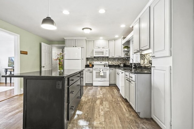 13 Hoyt Ave, Amesbury, MA 01913 - kitchen featuring white appliances, dark countertops, wood finished floors, backsplash, and recessed lighting