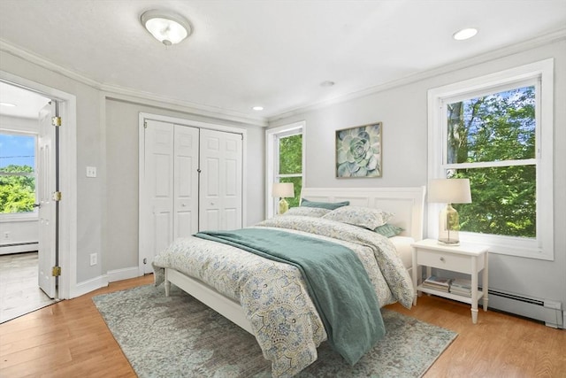 13 Hoyt Ave, Amesbury, MA 01913 - bedroom featuring crown molding, baseboard heating, light wood-style flooring, a closet, and recessed lighting