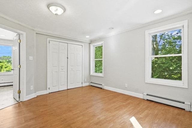 13 Hoyt Ave, Amesbury, MA 01913 - unfurnished bedroom featuring a baseboard heating unit, crown molding, light wood-type flooring, and recessed lighting