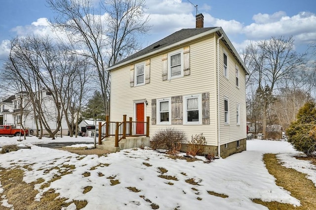 colonial-style house featuring a chimney