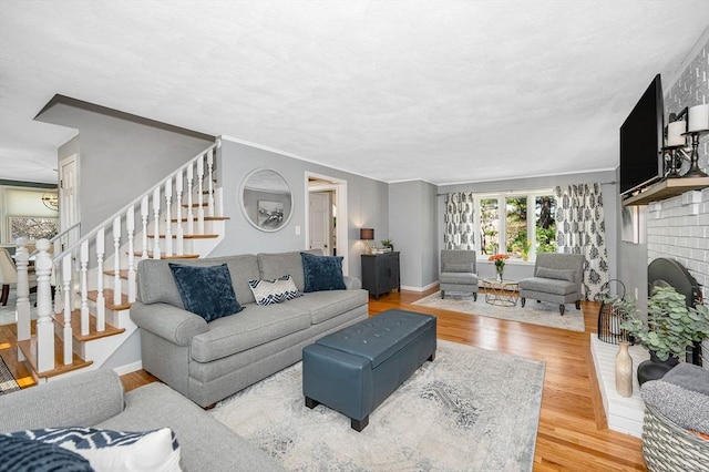 living room with stairway, baseboards, and wood finished floors