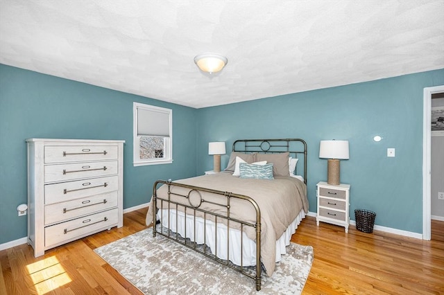 bedroom with baseboards and light wood-style floors