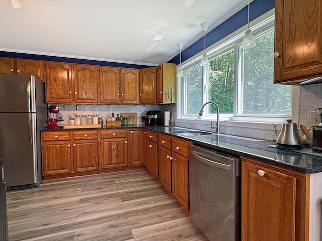 233 Old Wendell Rd, Northfield, MA 01360 - kitchen featuring stainless steel appliances, brown cabinetry, decorative backsplash, and light wood finished floors