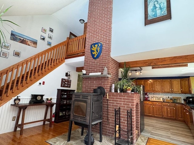 233 Old Wendell Rd, Northfield, MA 01360 - living room with light wood-style flooring, a wood stove, stairs, and high vaulted ceiling
