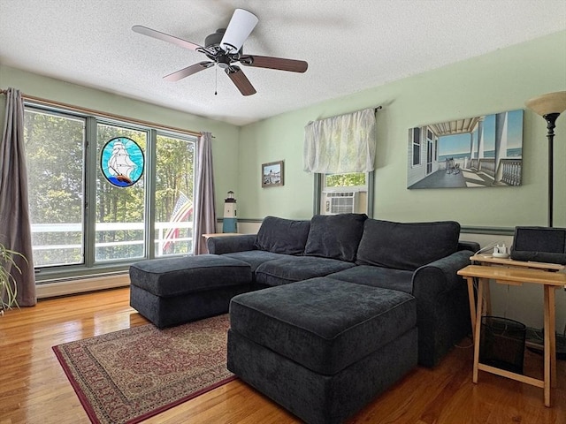 233 Old Wendell Rd, Northfield, MA 01360 - living room with a textured ceiling, cooling unit, wood finished floors, and ceiling fan