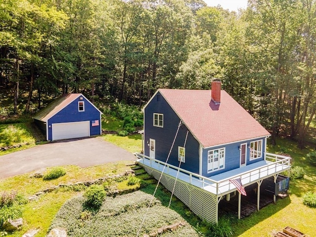 233 Old Wendell Rd, Northfield, MA 01360 - view of front of property with a garage, an outbuilding, a chimney, a view of trees, and a front yard
