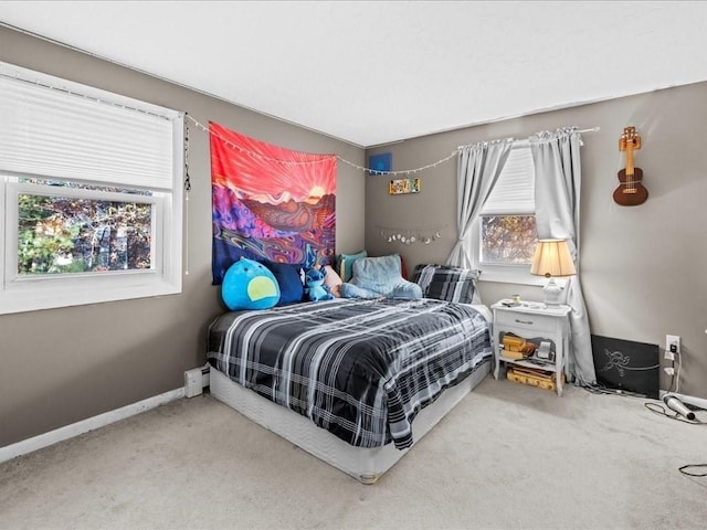 bedroom featuring baseboards and carpet flooring