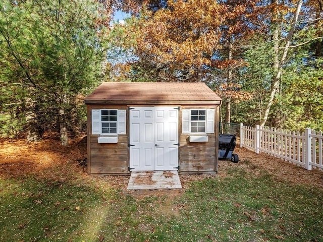 view of shed featuring fence