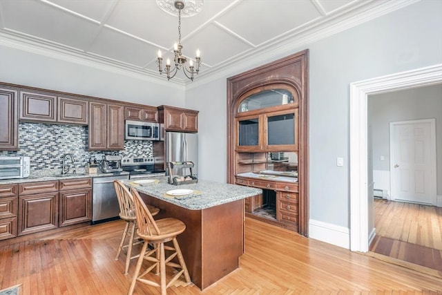 4 Mount Vernon Unit 1, Haverhill, MA 01830 - kitchen featuring stainless steel appliances, a chandelier, tasteful backsplash, a center island, and light wood-type flooring