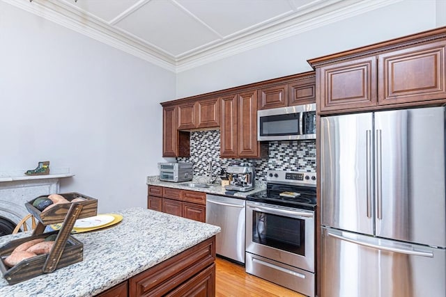 4 Mount Vernon Unit 1, Haverhill, MA 01830 - kitchen with stainless steel appliances, tasteful backsplash, light stone counters, ornamental molding, and a sink