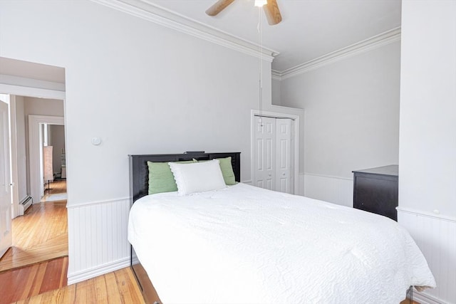 4 Mount Vernon Unit 1, Haverhill, MA 01830 - bedroom featuring a baseboard heating unit, ornamental molding, light wood-style flooring, wainscoting, and a closet