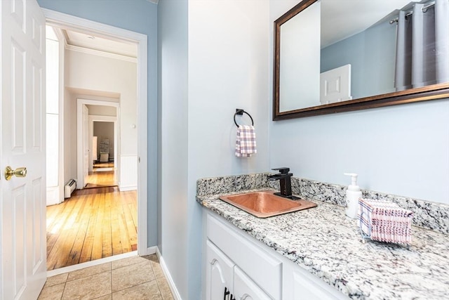 4 Mount Vernon Unit 1, Haverhill, MA 01830 - bathroom with vanity, crown molding, baseboards, tile patterned floors, and a baseboard heating unit