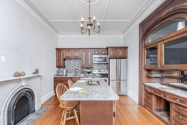 4 Mount Vernon Unit 1, Haverhill, MA 01830 - kitchen with stainless steel appliances, a chandelier, tasteful backsplash, and baseboards