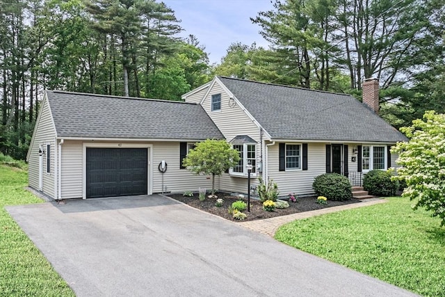 42 Howe St, Ipswich, MA 01938 - view of front facade with an attached garage, a chimney, asphalt driveway, a shingled roof, and a front yard