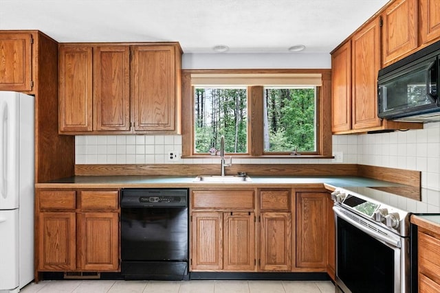 42 Howe St, Ipswich, MA 01938 - kitchen featuring black appliances, a sink, brown cabinetry, and backsplash