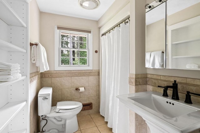 42 Howe St, Ipswich, MA 01938 - bathroom featuring tile walls, a sink, tile patterned flooring, toilet, and wainscoting