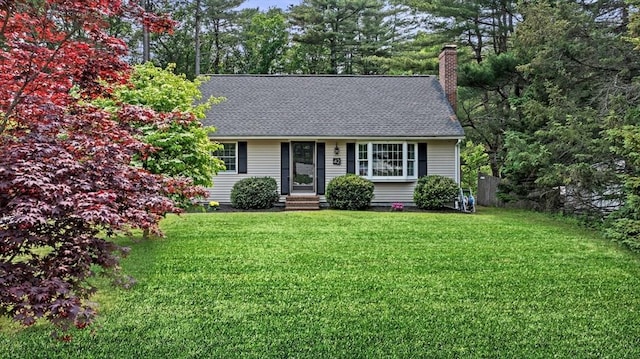 42 Howe St, Ipswich, MA 01938 - view of front of home with a chimney, a front yard, and a shingled roof