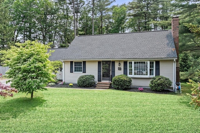 42 Howe St, Ipswich, MA 01938 - view of front of home with a front lawn, a chimney, and a shingled roof
