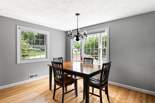 42 Howe St, Ipswich, MA 01938 - dining area with a chandelier, baseboards, and light wood-type flooring