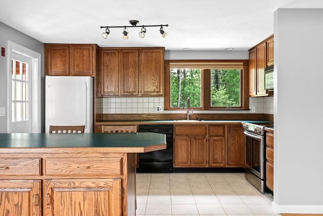 42 Howe St, Ipswich, MA 01938 - kitchen featuring freestanding refrigerator, electric stove, black dishwasher, a sink, and decorative backsplash