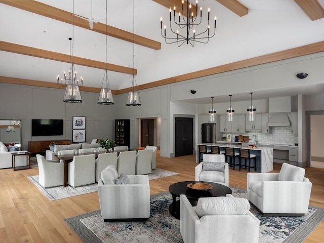 living room featuring beamed ceiling, high vaulted ceiling, and light hardwood / wood-style flooring