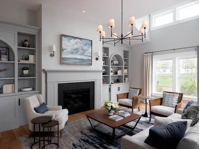 living room with wood-type flooring and a chandelier