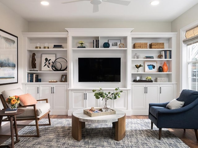 sitting room with dark wood-type flooring and ceiling fan
