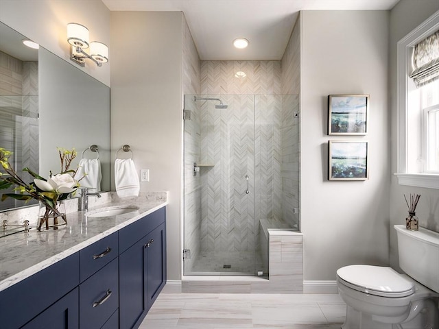 bathroom featuring vanity, toilet, and walk in shower